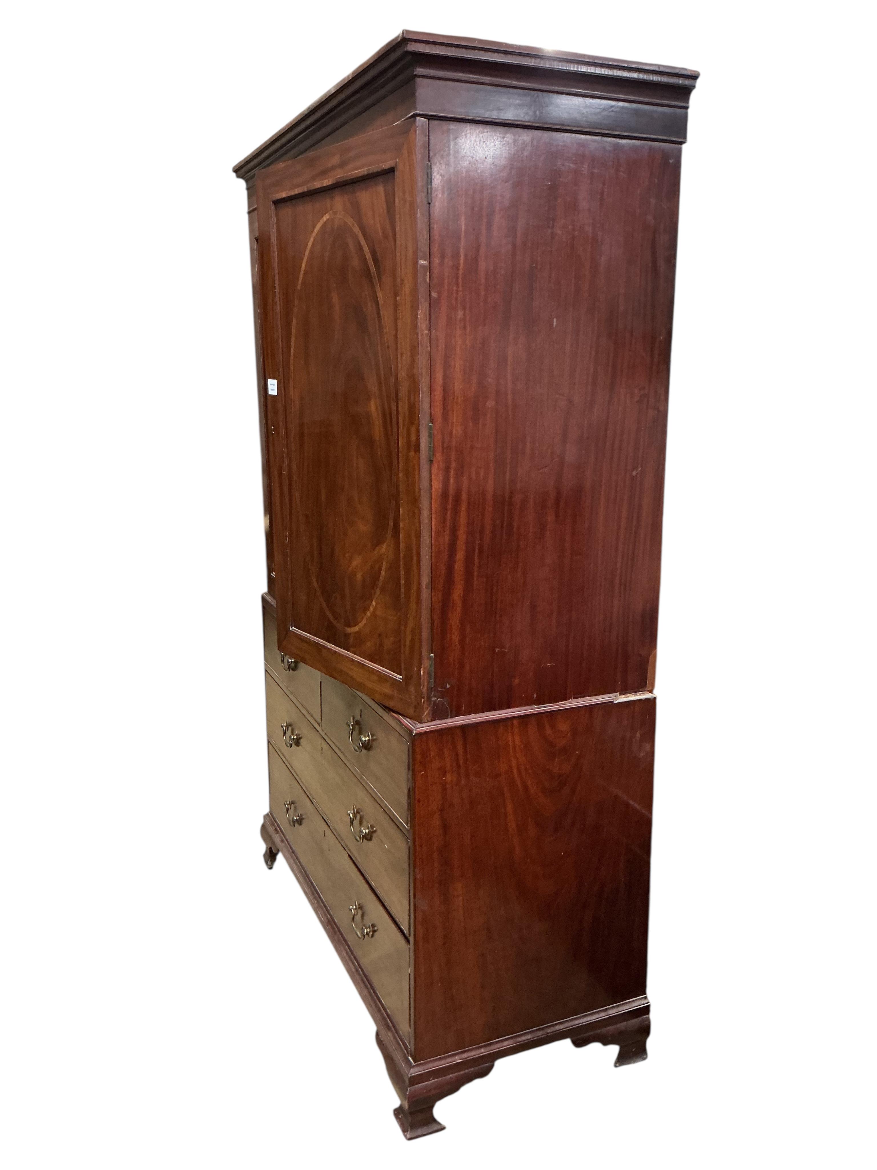 A George III satinwood banded mahogany linen press, converted to a hanging wardrobe, width 126cm, depth 55cm, height 206cm